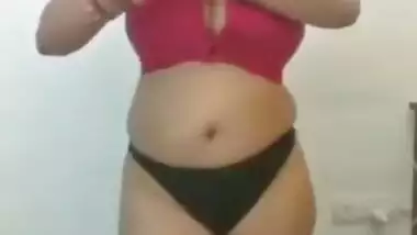 Full-bosomed Indian MILF unbuttons red bra to show her porn pomelos
